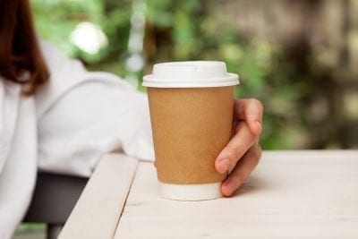 Why Gluten-Free Diets Don't Always Work | gluten free diets shutterstock 254161195 woman holding paper cup with coffee, gluten-free diet