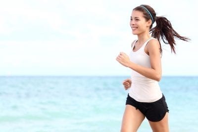 10 Easy Hacks to Boost Your Metabolism Naturally | metabolism shutterstock 96754267 woman running on seashore under the sun, boost metabolism naturally