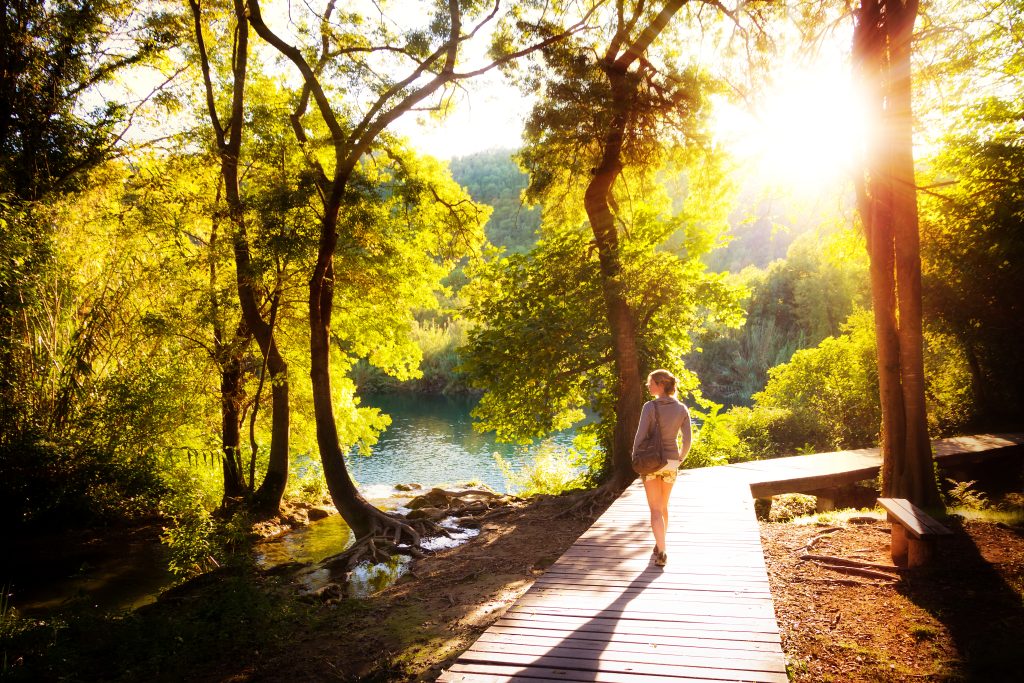 Herxheimer Reaction: 5 Most Helpful Tips on Dealing with It | Herxheimer reaction young woman walks in the national park at sunset Herxheimer reaction - young woman walks in the national park at sunset
