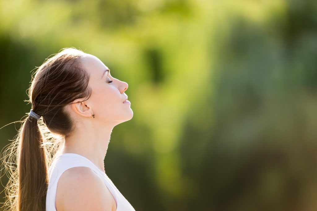 Beyond the Thyroid: The Thyroid German New Medicine Impact on Hashimoto's And Thyroid Symptoms | Thyroid German New Medicine woman with ponytail enjoying fresh air outdoor relaxing with eyes closed feeling alive breathing dreaming Thyroid German New Medicine - woman with ponytail enjoying fresh air outdoor, relaxing with eyes closed, feeling alive, breathing, dreaming