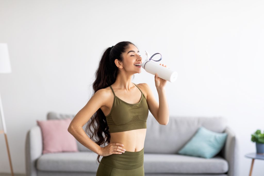 Cycle Mapping: The Best Foods, Workouts And Supplements for Your Cycle | Cycle Mapping woman drinking water or protein shake Cycle Mapping - woman drinking water or protein shake