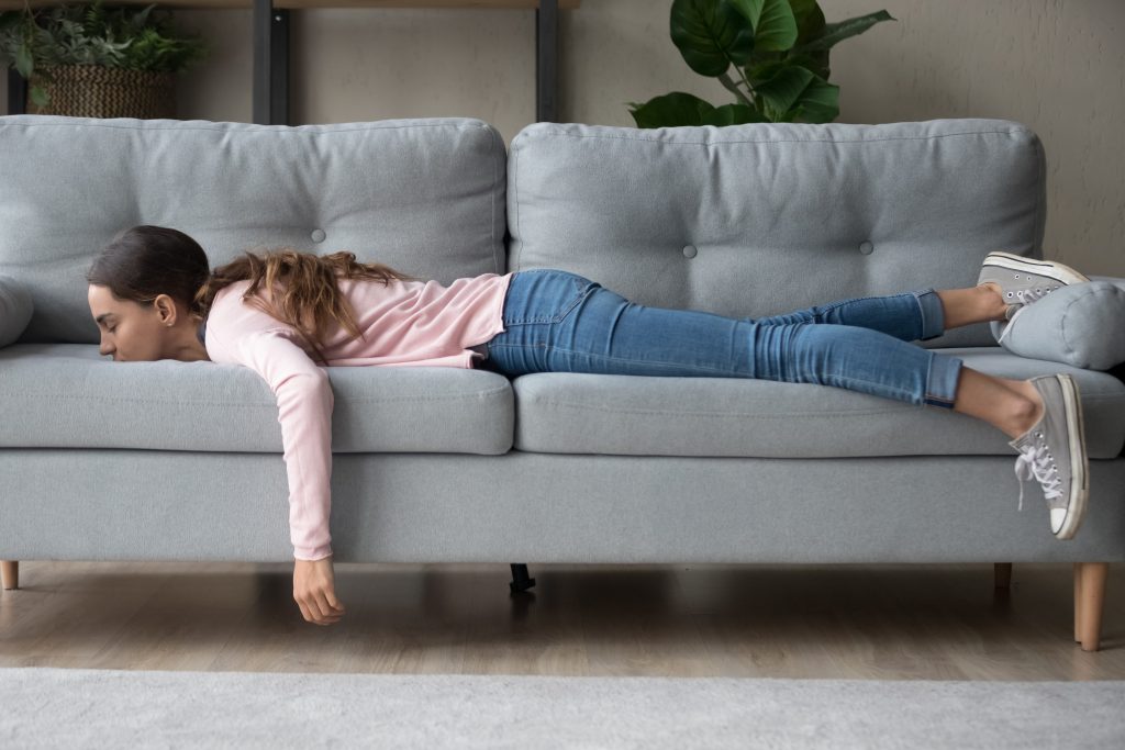 Hormone Imbalance 101: 4 Little-Known Causes Your Doctor Didn’t Tell You About | hormone imbalance girl lying rest at home in living room buried her face in couch feels exhaustion hormone imbalance - girl lying rest at home in living room buried her face in couch feels exhaustion
