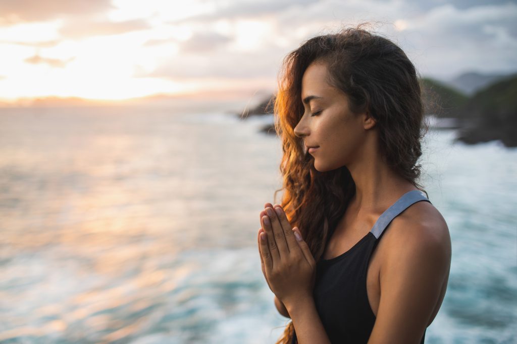 Discovering the Healing Power of Ho'oponopono: A Practice of Forgiveness | Hooponopono Young woman praying and meditating alone at sunset with beautiful ocean Ho'oponopono - Young woman praying and meditating alone at sunset with beautiful ocean