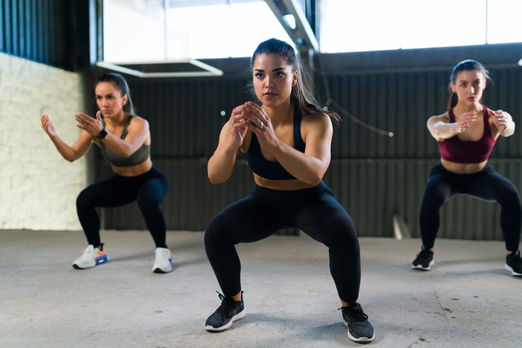 How to Get a Flat Stomach & Toned Muscles Without Starving or Over Exercising | How to Get a Flat Stomach And Toned Muscles women doing a cardio HIIT routine and squatting How to Get a Flat Stomach And Toned Muscles - women doing a cardio HIIT routine and squatting