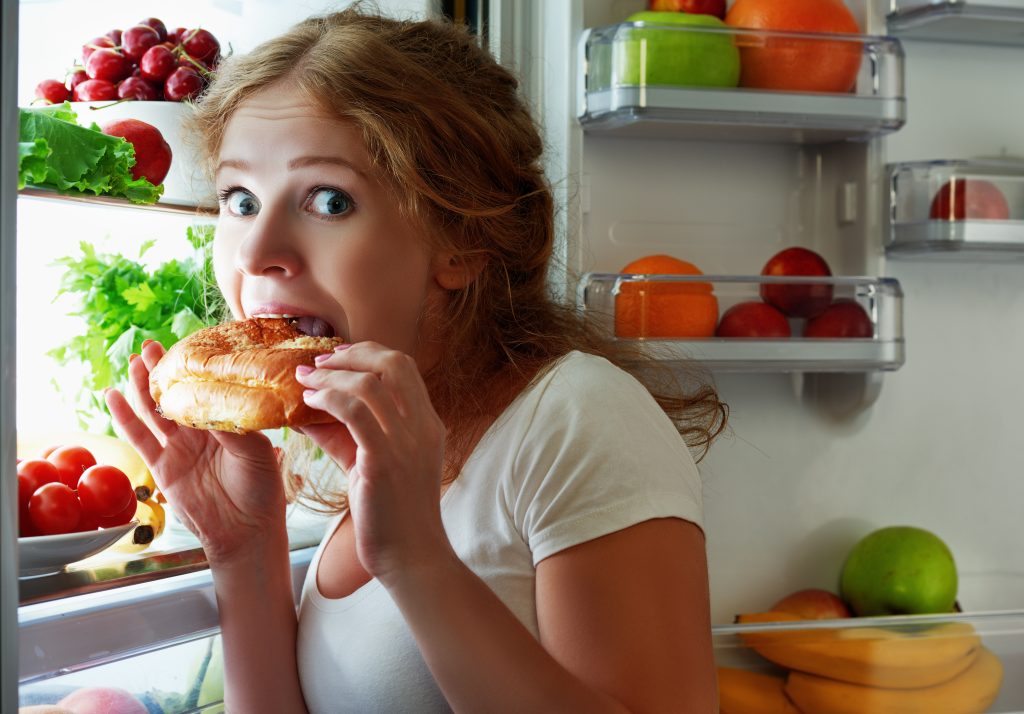 The Top 3 Essentials to Balance Hormones Naturally | balance hormone naturally woman eats sweets at night to sneak in a refrigerator balance hormones naturally - woman eats sweets at night to sneak in a refrigerator