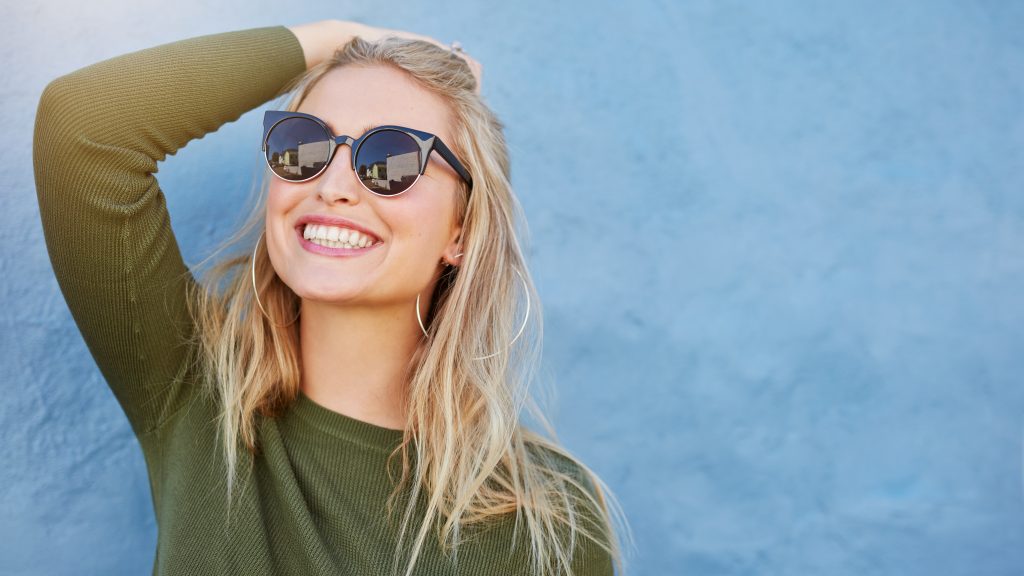 Get Rid of a UTI Fast: 10 Quick Natural UTI Remedies (No Antibiotics Included) | natural UTI remedies happy woman standing natural UTI remedies - happy woman standing
