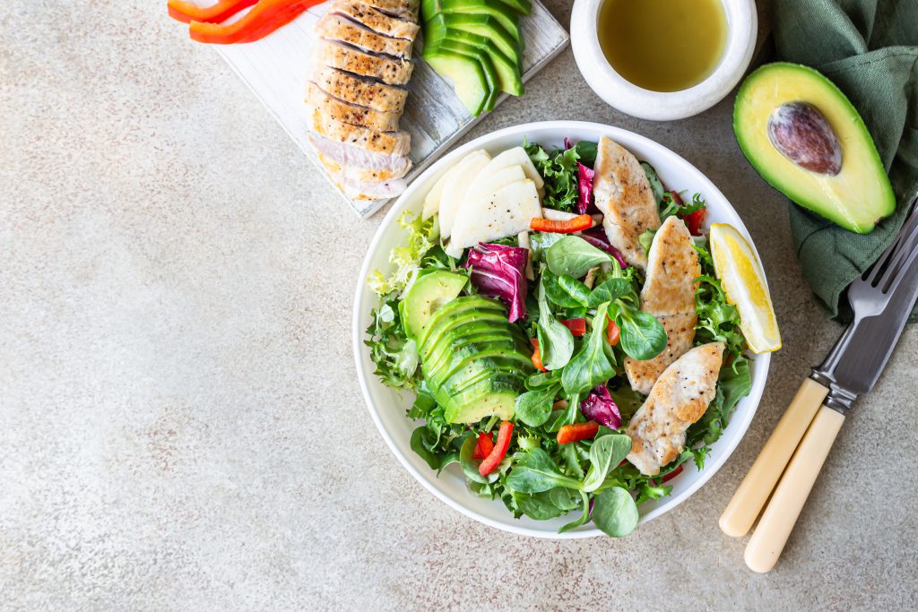 Nourishing Your Gut: A Guide to Delicious Gut-Loving Meals on the Go | gut loving meals Avocado apple bell pepper and grilled chicken salad with ingredients for making salad gut-loving meals - Avocado, apple, bell pepper and grilled chicken salad with ingredients for making salad