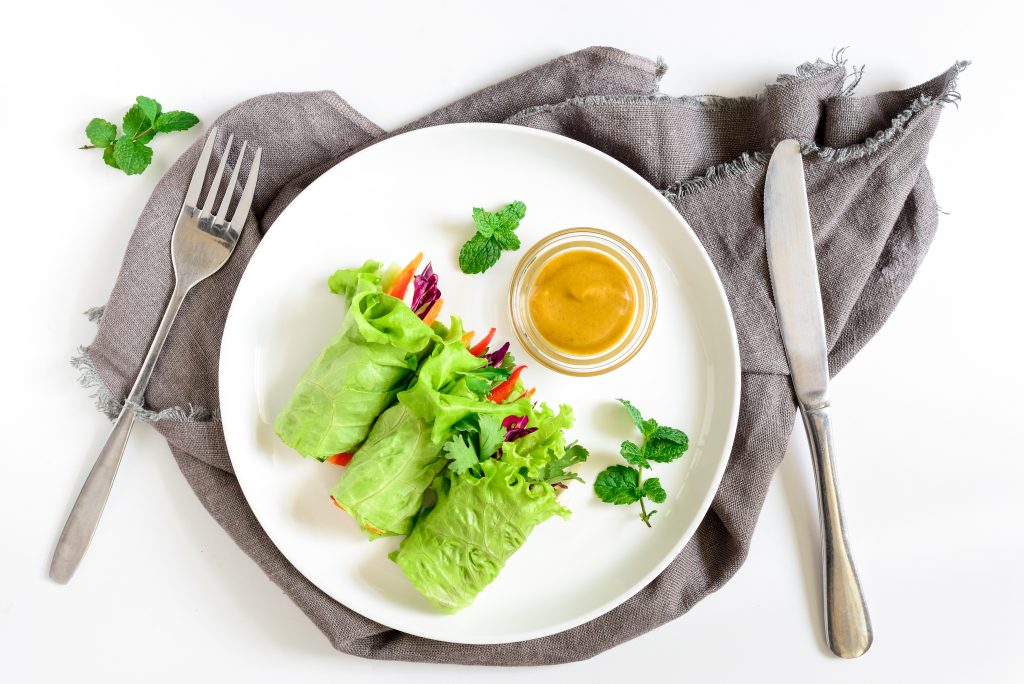 Nourishing Your Gut: A Guide to Delicious Gut-Loving Meals on the Go | gut loving meals Lettuce vegetarian wraps or rolls stuffed with freshly chopped juicy vegetables and herbs served with sauce and decorated with fresh mint leaves gut-loving meals - Lettuce vegetarian wraps or rolls stuffed with freshly chopped juicy vegetables and herbs, served with sauce and decorated with fresh mint leaves
