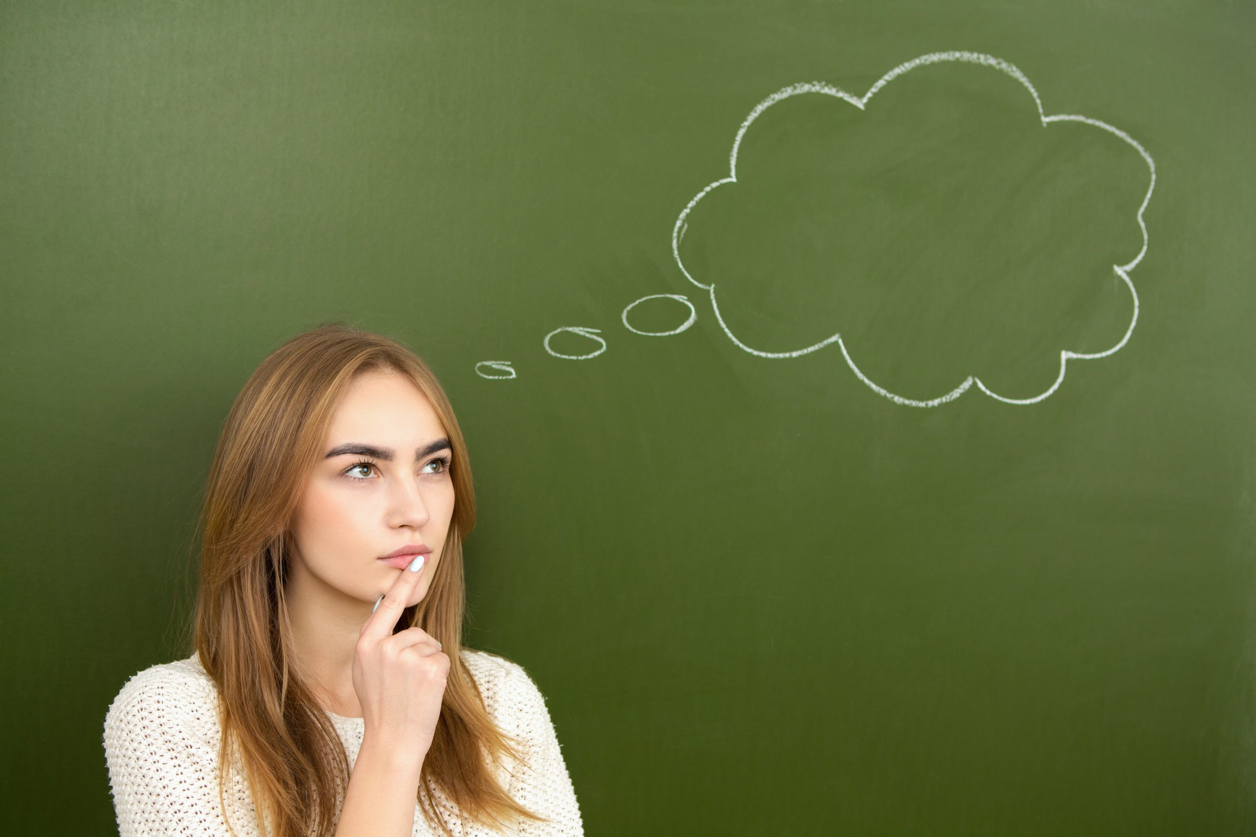 Eat for Your Gut Type: 8 Strategies to Boost Digestion | gut type Beautiful young girl thinking with her hand to her face standing in front of a chalkboard with a thought bubble drawn on imagine scaled gut type - Beautiful young girl thinking with her hand to her face standing in front of a chalkboard with a thought bubble drawn on imagine