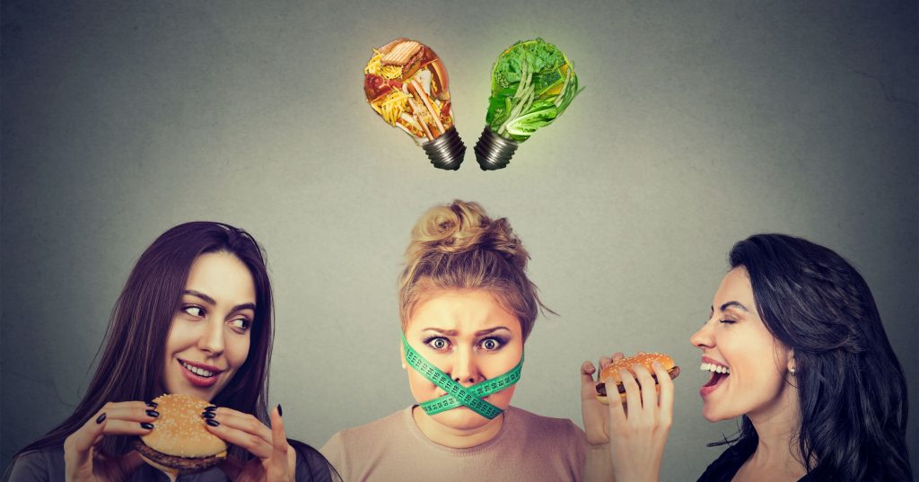 Not Eating Enough & Weight Gain: 10 Signs You’re Not Eating Enough | Not Eating Enough girl with measuring tape around her mouth and junk food and vegetables light bulbs above head Not Eating Enough - girl with measuring tape around her mouth and junk food and vegetables light bulbs above head