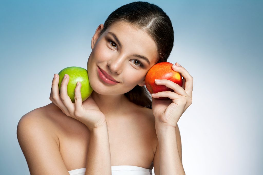 Eat for Your Gut Type: 8 Strategies to Boost Digestion Naturally | Strategies to Boost Digestion girl holding two apples in her hands Strategies to Boost Digestion - girl holding two apples in her hands