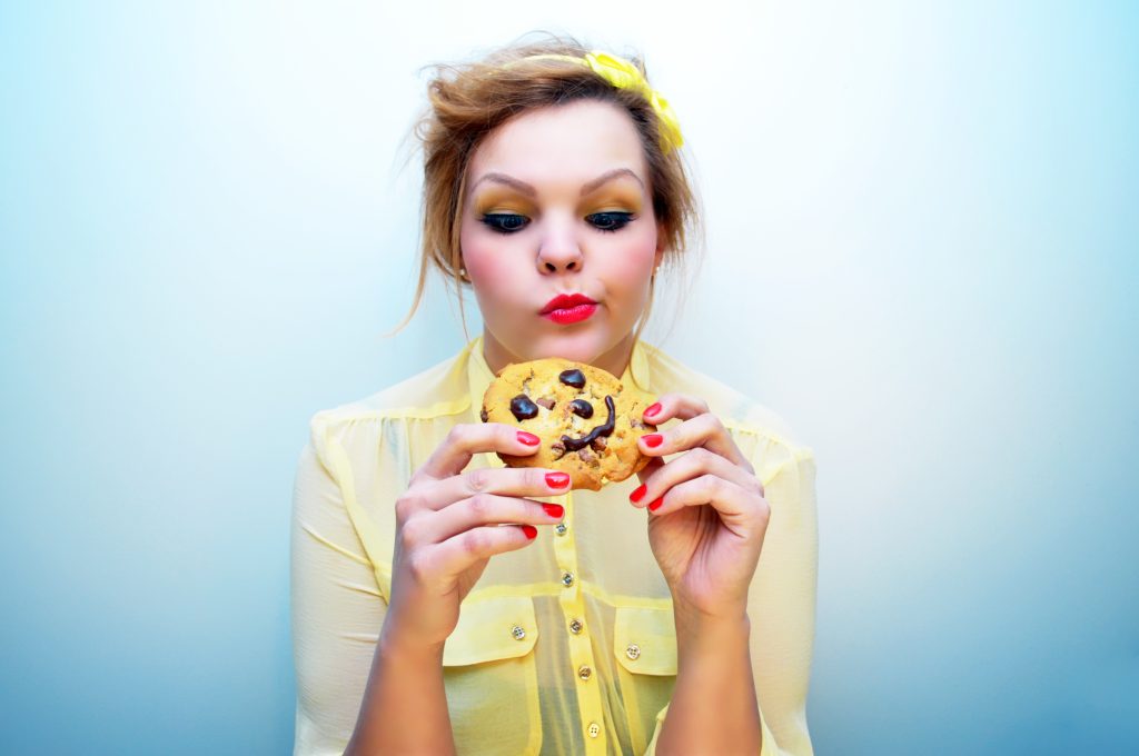 Eat for Your Gut Type: 8 Strategies to Boost Digestion Naturally | Strategies to Boost Digestion woman tempted to eat a chocolate chip cookie Strategies to Boost Digestion - woman tempted to eat a chocolate chip cookie