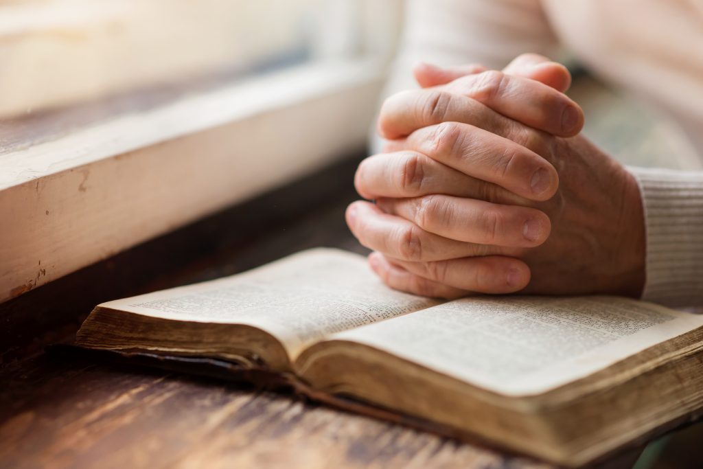 Spark Joy: The #1 Health Hack No One is Talking About to Heal Your Body with Your Mind | spark joy woman holding a bible in her hands and praying spark joy - woman holding a bible in her hands and praying