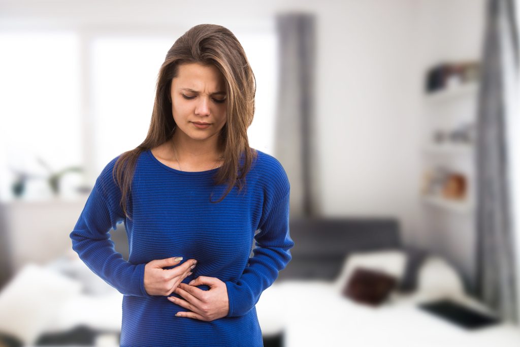 The 7 Gut Types: Which One Are You? | gut types Young woman suffering stomach ache pressing abdomen because of burn acid as digestive illness problem gut types - Young woman suffering stomach ache pressing abdomen because of burn acid as digestive illness problem