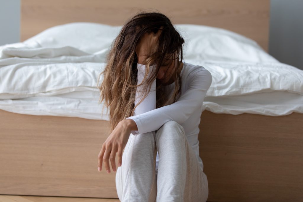 The 7 Gut Types: Which One Are You? | gut types upset young mixed race girl leaning back to bed sitting on floor gut types - upset young mixed race girl leaning back to bed sitting on floor