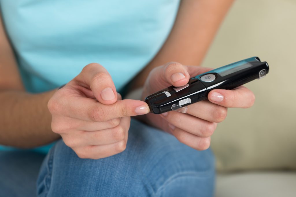 The 7 Gut Types: Which One Are You? | gut types young woman using glucometer to check blood sugar level at home gut types - young woman using glucometer to check blood sugar level at home