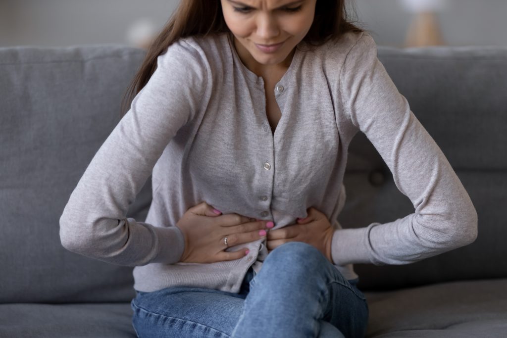 10 Health Issues That Can Happen After Eating Disorders + How to Heal | Eating Disorders Sick young woman in pain holding belly stomach feeling hurt abdomen ache gastritis pancreatitis symptoms or diarrhea Eating Disorders - Sick young woman in pain holding belly stomach feeling hurt abdomen ache gastritis pancreatitis symptoms or diarrhea