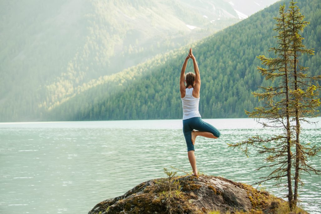 How to Lose Weight And 10x Your Health With Spark Joy | spark joy Young woman is practicing yoga at mountain lake spark joy - Young woman is practicing yoga at mountain lake